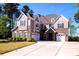 Attractive two-story home with a stone and siding exterior, showcasing a well-manicured lawn and a spacious driveway at 9878 Verdun Ct, Fort Mill, SC 29707