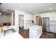 Open kitchen with white cabinets, stainless steel appliances, and a convenient island at 9878 Verdun Ct, Fort Mill, SC 29707