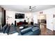 Living room featuring a sectional sofa, large TV, hardwood floors and stairway at 9878 Verdun Ct, Fort Mill, SC 29707