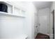 Mudroom area with coat hooks, shelving, and convenient access to the front door at 9878 Verdun Ct, Fort Mill, SC 29707