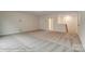 Large bonus room with neutral carpet flooring, perfect for entertaining or relaxing at 104 S Inneswood Ln # 30, Mooresville, NC 28115