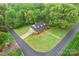 Aerial view of the home's setting, with a long driveway, lush trees, and manicured lawns at 109 Windmill Rd, Salisbury, NC 28147