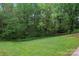 Serene backyard featuring a lush lawn and mature trees for privacy and shade at 109 Windmill Rd, Salisbury, NC 28147