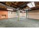 Unfinished basement with exposed ceiling, brick fireplace, and green carpet at 109 Windmill Rd, Salisbury, NC 28147