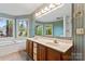Primary bathroom with dual sinks, soaking tub, and large windows at 109 Windmill Rd, Salisbury, NC 28147