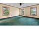 A sun-filled bedroom featuring three large windows and ceiling fan at 109 Windmill Rd, Salisbury, NC 28147