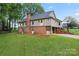 Exterior rear view of home showcasing an elevated deck and a brick foundation at 109 Windmill Rd, Salisbury, NC 28147