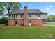 Back exterior view of a two-story home with siding, brick foundation and grassy lawn at 109 Windmill Rd, Salisbury, NC 28147