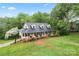 Stunning aerial view of the home with a lush lawn, mature trees, and inviting front porch at 109 Windmill Rd, Salisbury, NC 28147