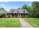 Inviting home with a welcoming front porch, complemented by manicured landscaping at 109 Windmill Rd, Salisbury, NC 28147