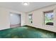 Empty room with large windows and green carpet at 109 Windmill Rd, Salisbury, NC 28147