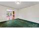 Empty living room with green carpet adjacent to kitchen at 109 Windmill Rd, Salisbury, NC 28147