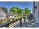 Relaxing balcony with seating area and a view of the lush greenery and detached garage at 1105 Reece Rd, Charlotte, NC 28209