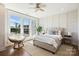 Bright bedroom features large windows, wood floors, and stylish furniture, creating a serene and inviting atmosphere at 1105 Reece Rd, Charlotte, NC 28209