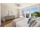 Bright bedroom featuring hardwood floors, ceiling fan, and large windows creating a relaxing atmosphere at 1105 Reece Rd, Charlotte, NC 28209