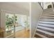 Spacious entryway with an open view of the office, hardwood floors, and a staircase at 1105 Reece Rd, Charlotte, NC 28209