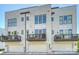 Modern townhouse exterior with a white brick facade and private balconies at 1105 Reece Rd, Charlotte, NC 28209