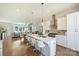 Open kitchen features an island with marble countertops, stainless steel appliances, and ample seating at 1105 Reece Rd, Charlotte, NC 28209