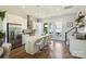 Elegant kitchen featuring a large island, stainless steel appliances, granite countertops, and stylish bar stools at 1105 Reece Rd, Charlotte, NC 28209