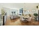 Bright living area with a marble fireplace, hardwood flooring, neutral paint colors, and large windows at 1105 Reece Rd, Charlotte, NC 28209