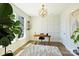 Well-lit home office with a modern desk, a large window, and a cozy rug at 1105 Reece Rd, Charlotte, NC 28209