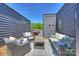 Private rooftop deck boasts outdoor seating, string lights, and offers ample space for entertaining at 1105 Reece Rd, Charlotte, NC 28209