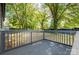 Deck with a wooden safety railing provides an outdoor space for relaxation and entertainment at 111 Quinn Ave, Gastonia, NC 28054