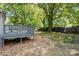 Backyard view of the wooden safety railing of deck and large mature trees at 111 Quinn Ave, Gastonia, NC 28054