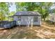 Back exterior view of a gray home showcasing a small deck and a well-maintained lawn at 111 Quinn Ave, Gastonia, NC 28054