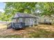 A well kept backyard featuring a charming single-story home with gray siding and a small deck at 111 Quinn Ave, Gastonia, NC 28054