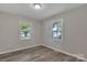 Bedroom with two windows and wood-look floors at 111 Quinn Ave, Gastonia, NC 28054