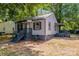 View of a single story home with gray siding, gray trim, and a covered porch entry at 111 Quinn Ave, Gastonia, NC 28054