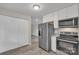 Cozy kitchen with stainless steel appliances, white cabinets, and pantry at 111 Quinn Ave, Gastonia, NC 28054