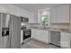 Bright kitchen with stainless steel appliances, white cabinets, and light countertops at 111 Quinn Ave, Gastonia, NC 28054