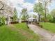 Large backyard with a gravel driveway, shed, and partially fenced yard at 1113 Gregory Ln, Statesville, NC 28677