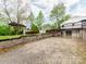 Backyard featuring a gravel drive, shed, and wooden fence surrounding the property at 1113 Gregory Ln, Statesville, NC 28677