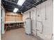 Basement area featuring a water heater, unfinished ceiling, and a workbench at 1113 Gregory Ln, Statesville, NC 28677