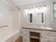 Bright bathroom with a tub and vanity with dual mirrors at 1113 Gregory Ln, Statesville, NC 28677