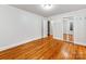 Large bedroom with hardwood floors, closet with mirrors, and neutral paint at 1113 Gregory Ln, Statesville, NC 28677