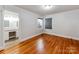 This bedroom has hardwood flooring, fresh paint, and lots of natural light at 1113 Gregory Ln, Statesville, NC 28677