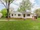 Charming single-story white brick home with well-manicured lawn and inviting front porch at 1113 Gregory Ln, Statesville, NC 28677