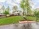 Charming home with lush front yard, steps leading to the entrance, and mature trees at 1113 Gregory Ln, Statesville, NC 28677