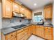 This kitchen features gray countertops, wood cabinets, and a stainless steel hood at 1113 Gregory Ln, Statesville, NC 28677