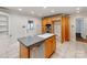 An open kitchen features an island sink, stainless steel dishwasher, and wood cabinets at 1113 Gregory Ln, Statesville, NC 28677