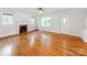 Living room with hardwood floors, a ceiling fan, and a classic marble fireplace at 1113 Gregory Ln, Statesville, NC 28677
