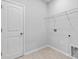 Clean laundry room with tile flooring, door, and wired shelving at 1125 Hallman Branch Ln, Lincolnton, NC 28092