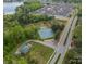 Overhead view of tennis courts and the surrounding neighborhood with mature trees, offering recreational amenities at 117 Middleton Pl, Mooresville, NC 28117