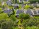 Aerial shot of a home nestled among lush trees, showcasing its backyard trampoline and neighborhood setting at 117 Middleton Pl, Mooresville, NC 28117