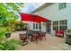 Inviting back patio with an outdoor dining set, pergola, and mature trees, ideal for entertaining at 117 Middleton Pl, Mooresville, NC 28117