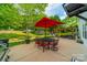 Inviting backyard with manicured lawn, trampoline, patio, pergola, and outdoor dining area at 117 Middleton Pl, Mooresville, NC 28117